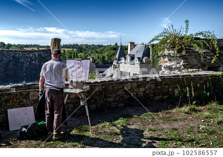 Artist Paints Picture In Scenic Village Rochefort En Terre In The Department Of Morbihan In Brittany, France Artist Paints Picture In Scenic Village Rochefort En Terre In The Department Of Morbihan In Brittany, France 102586557