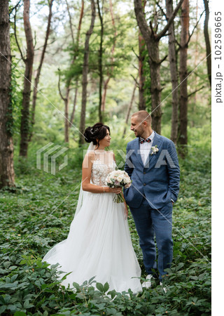 wedding walk of the bride and groom in the deciduous forest wedding walk of the bride and groom in the deciduous forest 102589665