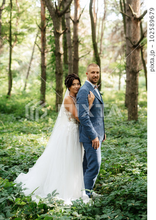 wedding walk of the bride and groom in the deciduous forest 102589679