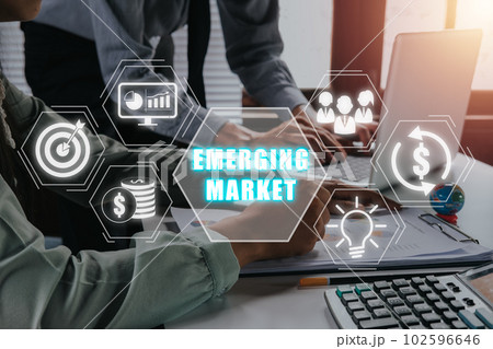 Emerging markets analysis concept, Business team working on laptop computer and analyzing finance data with emerging markets icon on virtual screen. Emerging markets analysis concept, Business team working on laptop computer and analyzing finance data with emerging markets icon on virtual screen. 102596646