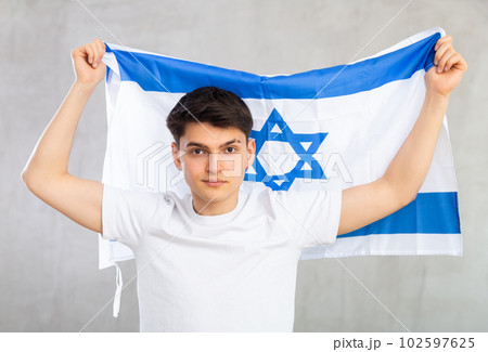 Guy holding the Israel flag in her hands Guy holding the Israel flag in her hands 102597625