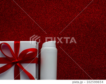 White jar with face cream is on red paper background White jar with face cream is on red paper background 102599654