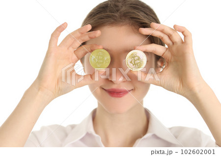 Woman holds golden coins with bitcoin symbol against eyes 102602001