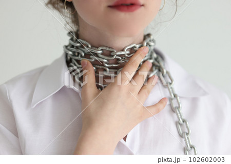 Woman touches wrapped around neck chain feeling throat pain 102602003