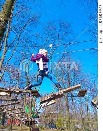 girl climbing in adventure rope park 102602972