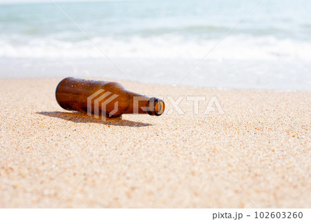 Glass bottle on the beach 102603260