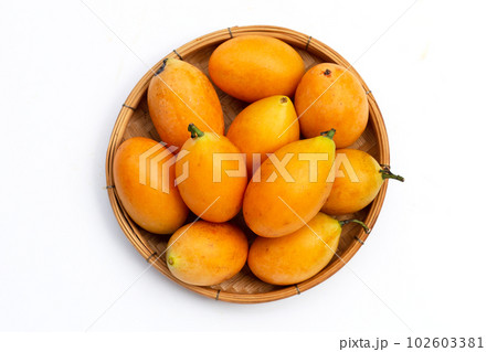 Marian plum fruit in bamboo weave plate on white background Marian plum fruit in bamboo weave plate on white background 102603381