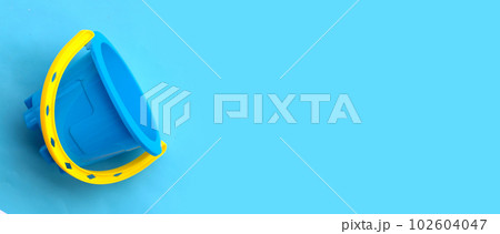 Plastic toys, Bucket on blue background. Summer background concept Plastic toys, Bucket on blue background. Summer background concept 102604047