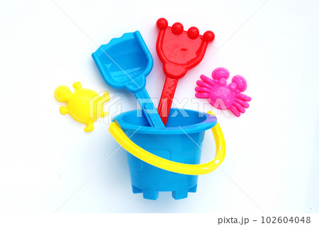 Plastic toys, shovels in bucket for sand on white background. Summer background concept 102604048