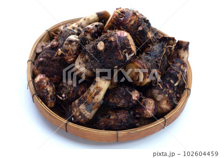 Organic taro fruit in bamboo weave plate on white background. Organic taro fruit in bamboo weave plate on white background. 102604459