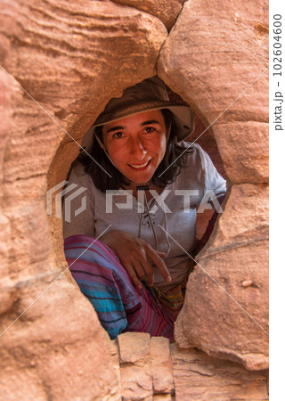 Woman in a small cave Woman in a small cave 102604600