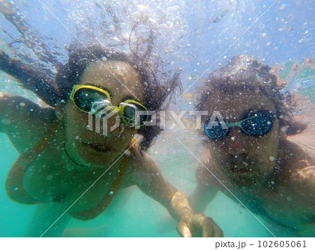 Couple having fun underwater in the sea Couple having fun underwater in the sea 102605061