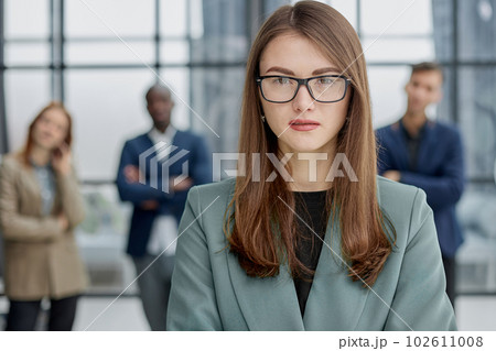 Portrait of a confident young businesswoman standing with her arms crossed in an office 102611008