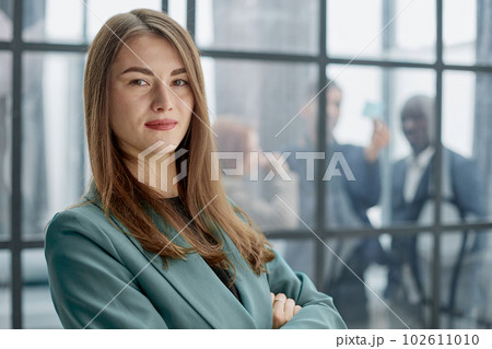 Portrait of a confident young businesswoman standing with her arms crossed in an office 102611010