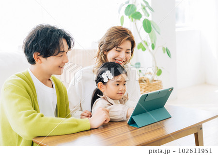 リビングでタブレットを見る親子 102611951