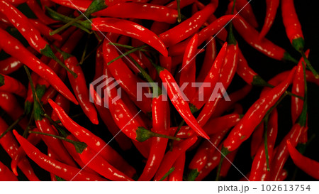 Chilli peppers flying up in the air. Freeze motion. Isolated on black background. Chilli peppers flying up in the air. Freeze motion. Isolated on black background. 102613754