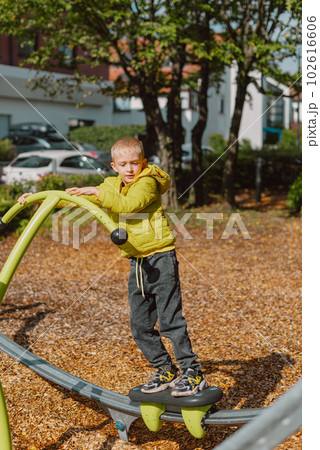 Funny cute happy baby playing on the playground. The emotion of happiness, fun, joy. Smile of a child. boy playing on the playground Funny cute happy baby playing on the playground. The emotion of happiness, fun, joy. Smile of a child. boy playing on the playground 102616606
