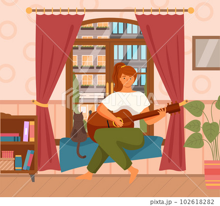 Woman is playing the guitar sitting in armchair. The musician composes songs, sings at home 102618282