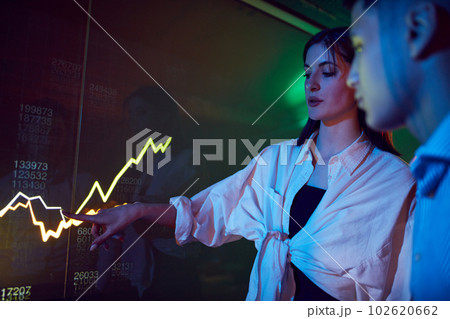 Colleagues at business meeting, conference making professional presentation, showing graphs on digital screen. Trade market 102620662