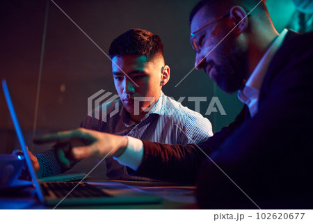 Close-up of two people, businessman showing trainee information on atop. Employment. Modern office 102620677