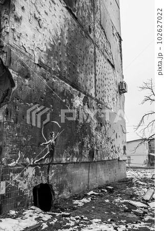 IRPIN, UKRAINE - NOVEMBER 29, 2022: Gymnast with ribbon - Banksy graffiti in Irpin, Ukraine, black and white photo IRPIN, UKRAINE - NOVEMBER 29, 2022: Gymnast with ribbon - Banksy graffiti in Irpin, Ukraine, black and white photo 102627022