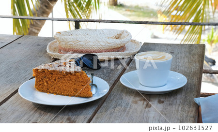 Close-up of fresh coffee on a terrace of cafe or restaurant over palm trees in sunny day. Summer vacation and travel concept 102631527