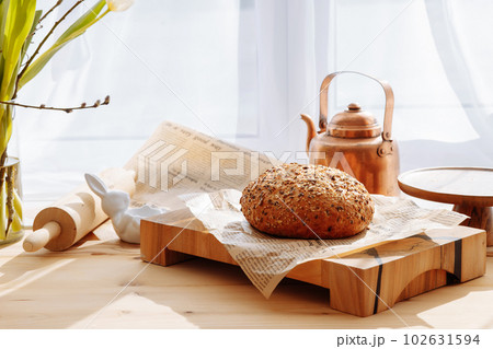 Bread on a wooden cutting board Bread on a wooden cutting board 102631594