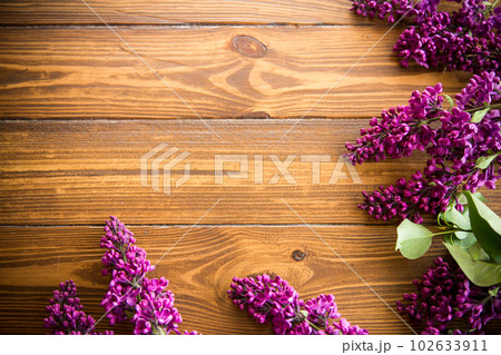 The beautiful lilac on a wooden background The beautiful lilac on a wooden background 102633911