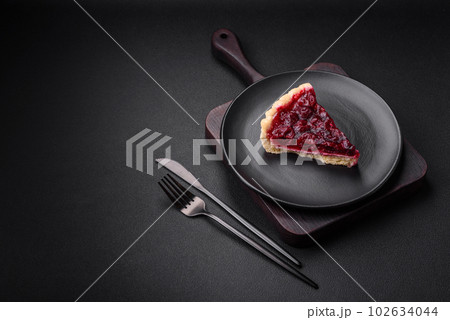 Delicious fragrant sweet pie with cherry berries on a ceramic plate Delicious fragrant sweet pie with cherry berries on a ceramic plate 102634044
