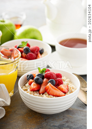 Steel cut oatmeal porridge with fresh berries Steel cut oatmeal porridge with fresh berries 102634104