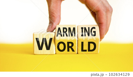 Warming world symbol. Concept words Warming world on wooden cubes. Beautiful yellow table white background. Businessman hand. Business, ecological and warming world concept. Copy space. Warming world symbol. Concept words Warming world on wooden cubes. Beautiful yellow table white background. Businessman hand. Business, ecological and warming world concept. Copy space. 102634129