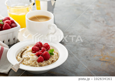 Steel cut oatmeal porridge with raspberry and coconut 102634161