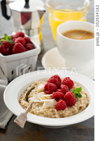 Steel cut oatmeal porridge with raspberry and coconut Steel cut oatmeal porridge with raspberry and coconut 102634162