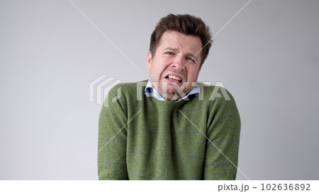 The young European man is crying from a life failure. His girlfriend left him and he lost his job. Unstable mental state 102636892