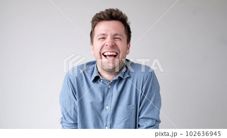 European funny young man is laughing loudly. Positive emotion European funny young man is laughing loudly. Positive emotion 102636945