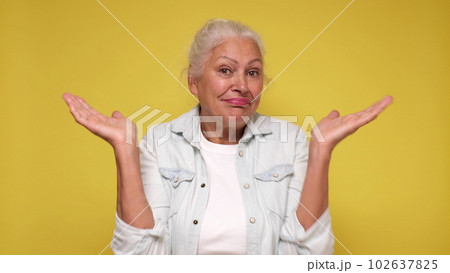Senior European woman shrugs her shoulders in confusion Senior European woman shrugs her shoulders in confusion 102637825