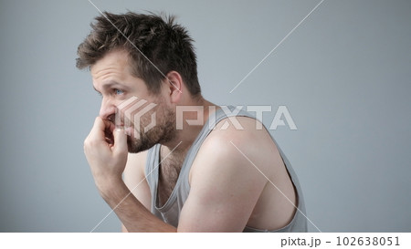 Mature caucasian man looking stressed and nervous with hands on mouth biting nails. 102638051