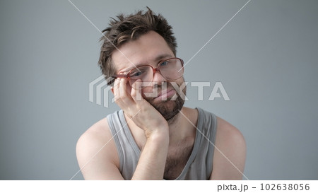 Portrait of sad alcoholic mature man in big glasses. 102638056