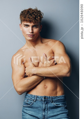 man studio male fitness lifestyle muscle gray bicep jeans shirtless 102648090