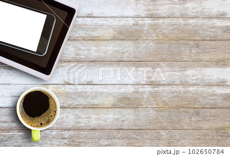 Hot coffee in a green cup on old wooden table Hot coffee in a green cup on old wooden table 102650784