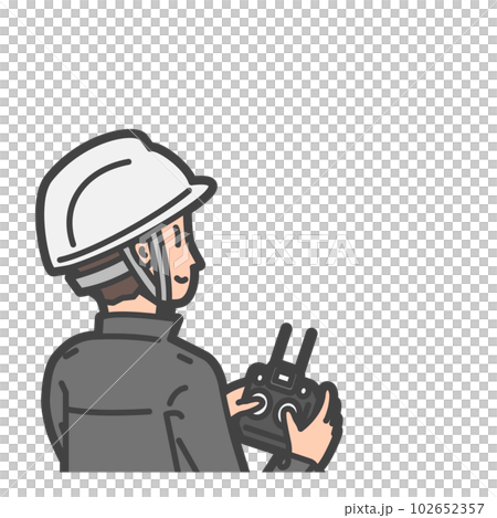 A worker / pilot who wears a helmet and operates a drone / radio control with a propo 102652357