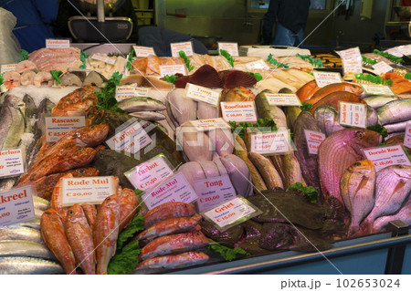 Amsterdam, Netherlands - Nov 29, 2019 : Food stall at Albert Cuyp Market in Amsterdam, Netherlands on Nov 29, 2019. Amsterdam, Netherlands - Nov 29, 2019 : Food stall at Albert Cuyp Market in Amsterdam, Netherlands on Nov 29, 2019. 102653024