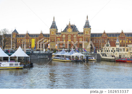 Amsterdam, Netherlands - Nov 27, 2019 : Beautiful Amsterdam Central station at twilight in Amsterdam, Netherlands on Nov 27, 2019. Amsterdam, Netherlands - Nov 27, 2019 : Beautiful Amsterdam Central station at twilight in Amsterdam, Netherlands on Nov 27, 2019. 102653337