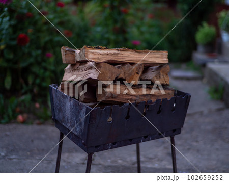 A small folding portable brazier filled with woods A small folding portable brazier filled with woods 102659252