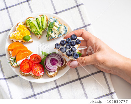 Rainbow sandwiches heart shape on white table Rainbow sandwiches heart shape on white table 102659777