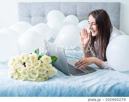 Woman lying on bed with decorations with balloons for Birthday party Woman lying on bed with decorations with balloons for Birthday party 102660279