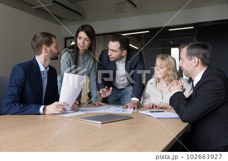 Diverse business team colleagues working on project plan Diverse business team colleagues working on project plan 102663927