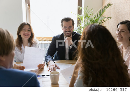 Workmates joking, enjoy friendly workflow, engaged in briefing 102664557