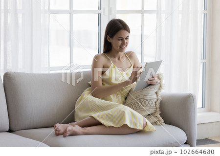 Positive cheerful young adult girl enjoying leisure, wireless Internet connection Positive cheerful young adult girl enjoying leisure, wireless Internet connection 102664680