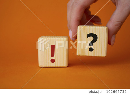 Question mark and exclamation mark symbol. Businessman hand is making a choice between Question mark and exclamation mark symbol. Beautiful orange background. Business concept. Copy space. Question mark and exclamation mark symbol. Businessman hand is making a choice between Question mark and exclamation mark symbol. Beautiful orange background. Business concept. Copy space. 102665732